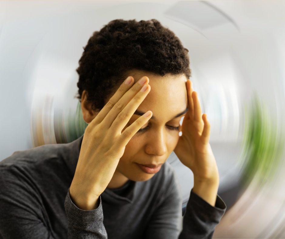Photo of a woman holding her face in pain in front of a warped background.